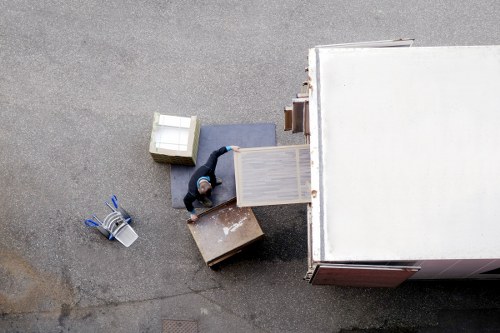 Professional mover loading household items into a van in Leyton