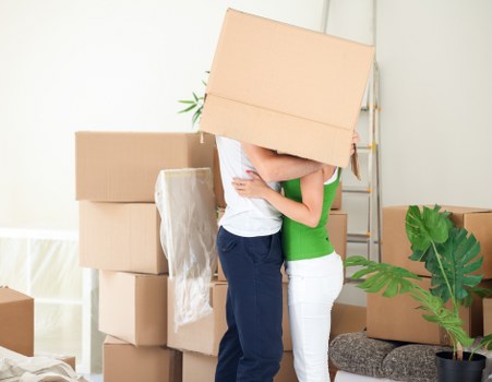 Stacked moving boxes and furniture packed for a home move in Leyton